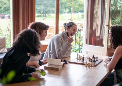 Students playing chess at Brockwood Park School