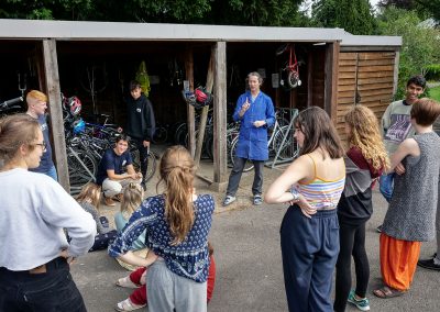 Students and Staff in the bicycle shed at Brockwood Park School