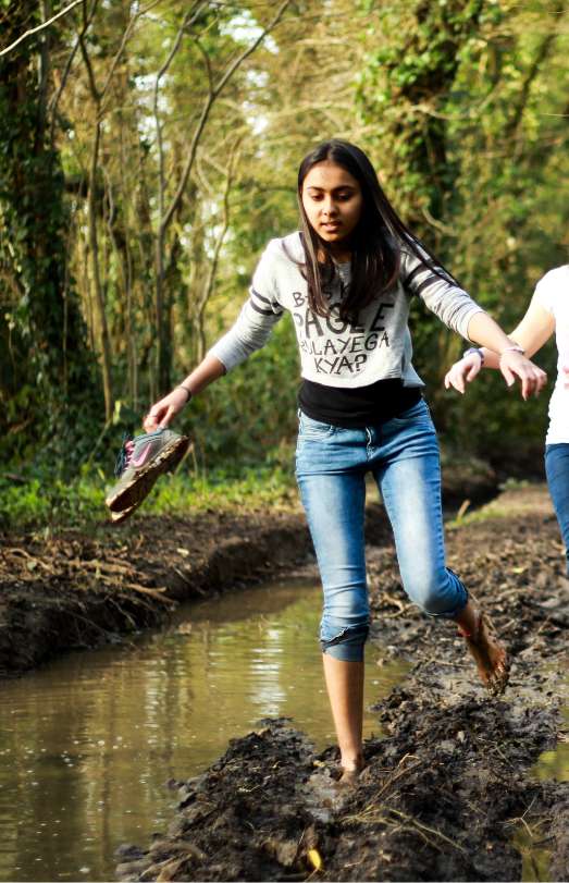 A Brockwood Park School student exploring nature barefoot
