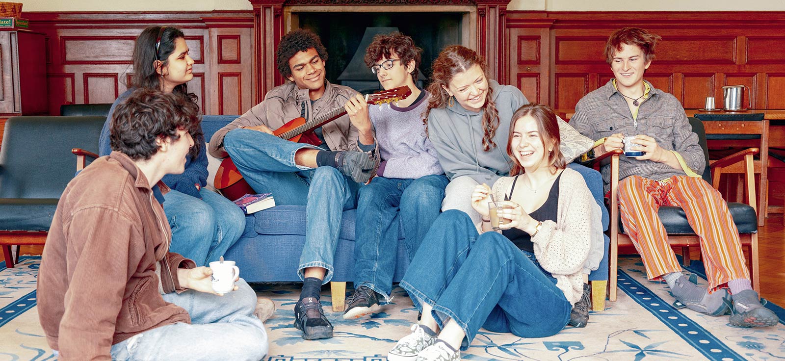 Brockwood Park School students engaging playfully while playing guitar and singing